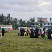 people at a kids carnival on a grass field