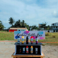 setup of "rainbow bottle race" in a kids Eid carnival