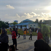 people walking around, standing, taking part in carnival games