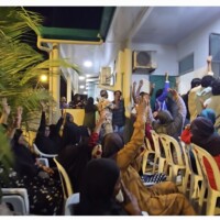 Locals of Thimarafushi raising their hands to vote on topics