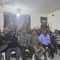 Locals raising hands to vote