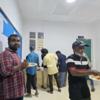Locals eating from buffet area
